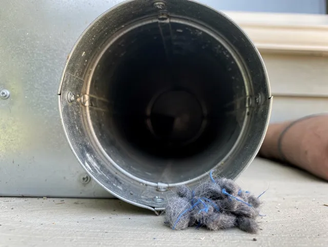 Beaumont Dryer Vent Cleaning technician using specialized equipment to clear severe dryer vent blockage in Beaumont